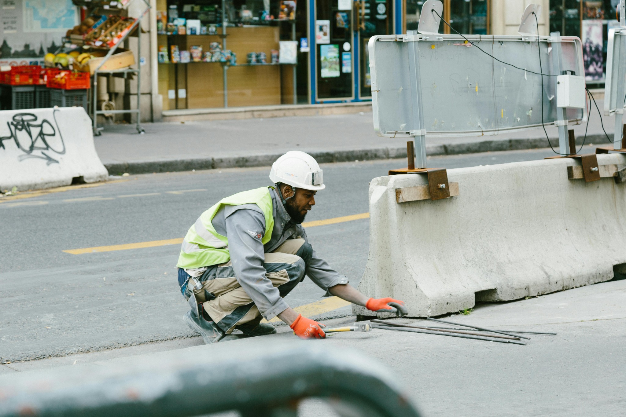 Worker in high-visibility clothing working in a street work zone